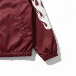 Urban coach jacket close-up – branded snap and stitching detail